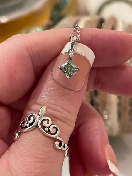 Half of a CT (.50CT) certified Princess Cut Moissanite Blue Diamond Necklace & Pendant. 18" 925 sterling silver.